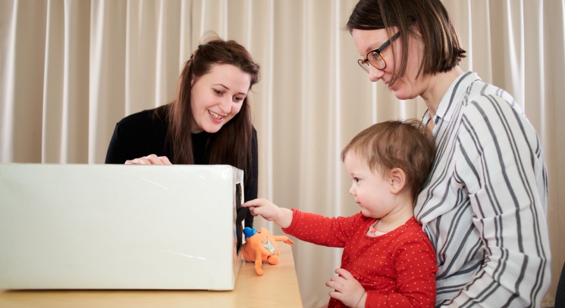 Baby looking for objects in box