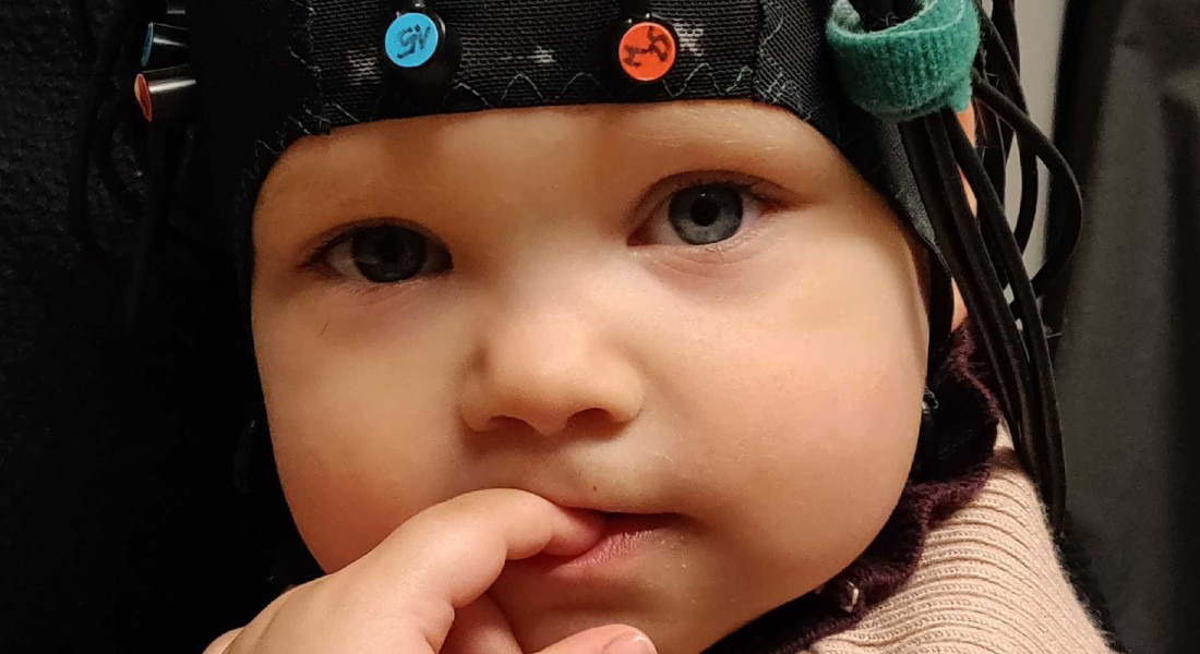 Baby iført en af de hætter som forskerne i Center for Småbørns Kognition vil bruge til at måle hjerneaktivitet hos både børn og forældre. Foto: Center for Småbørns Kognition