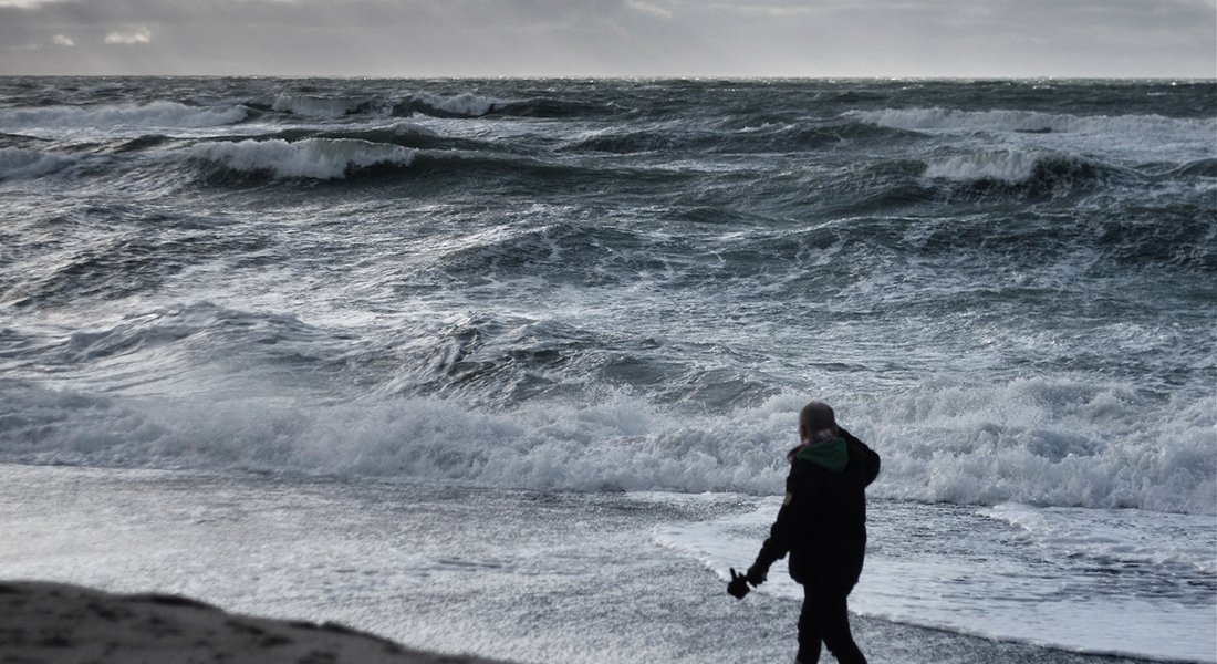 Man watching North Sea waves.